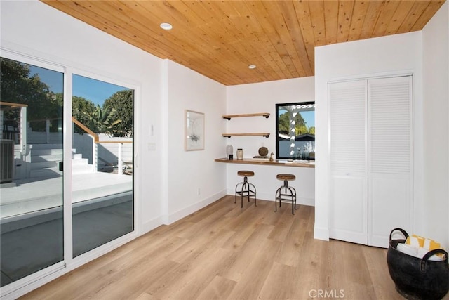 interior space with wood ceiling and light hardwood / wood-style floors