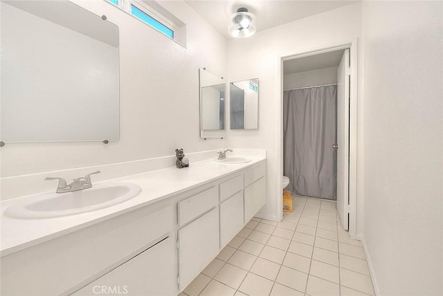 bathroom featuring toilet, tile patterned flooring, and vanity