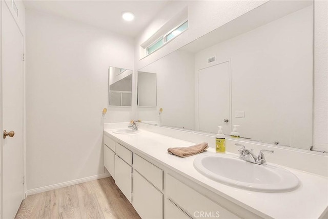 bathroom with hardwood / wood-style flooring and vanity