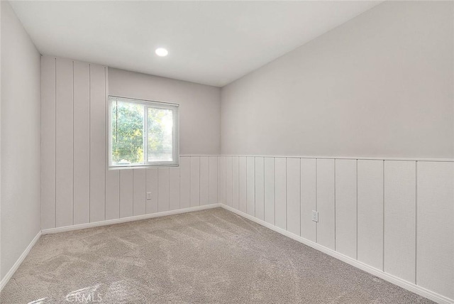 unfurnished room featuring light carpet