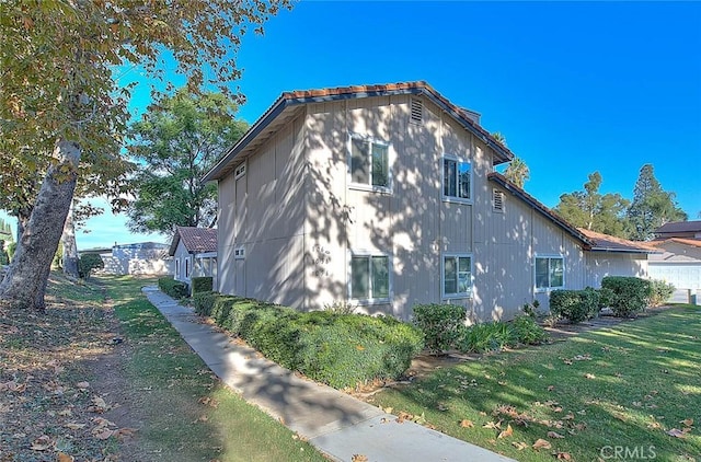 view of property exterior with a lawn