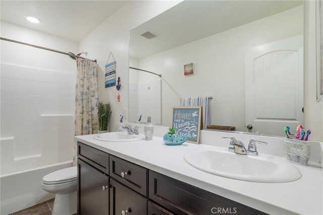 full bathroom featuring tile patterned floors, toilet, vanity, and shower / bathtub combination with curtain