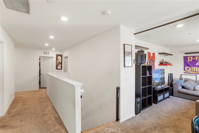 hall featuring light colored carpet, visible vents, an upstairs landing, and recessed lighting