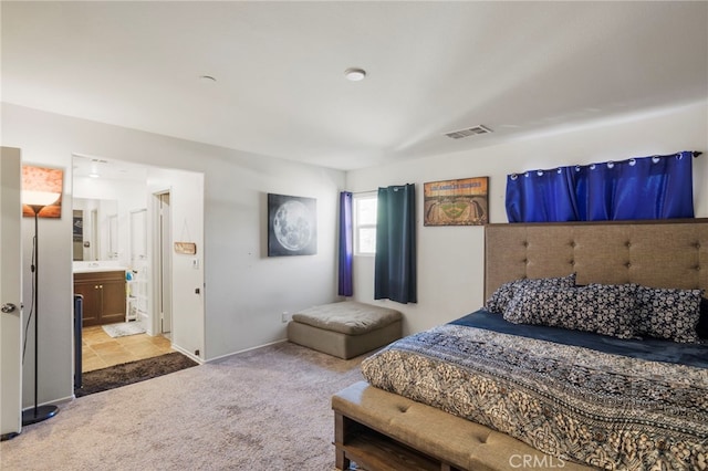 carpeted bedroom featuring ensuite bathroom