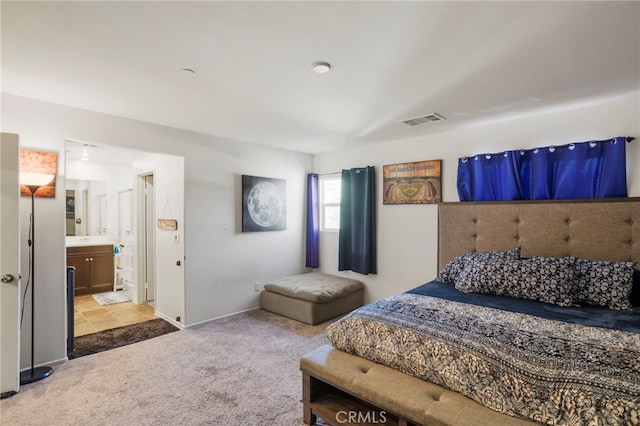 bedroom featuring light colored carpet, visible vents, connected bathroom, and baseboards