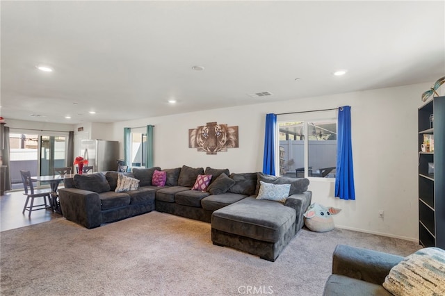 living room with light colored carpet, visible vents, baseboards, and recessed lighting