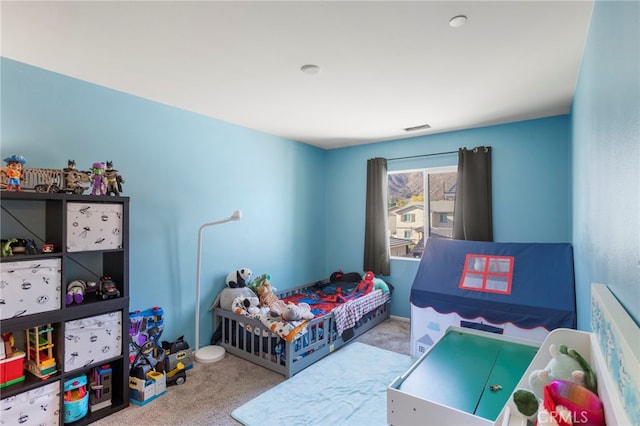 bedroom featuring visible vents and light colored carpet