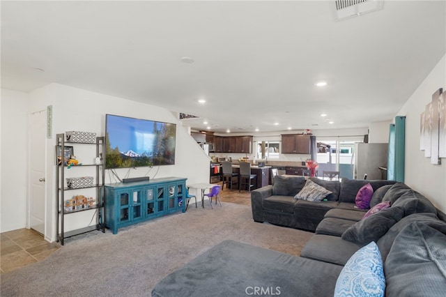 living room with light colored carpet, visible vents, and recessed lighting