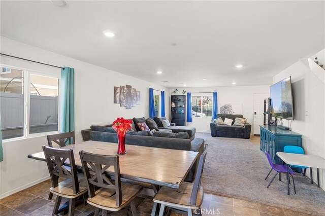 carpeted dining room featuring plenty of natural light