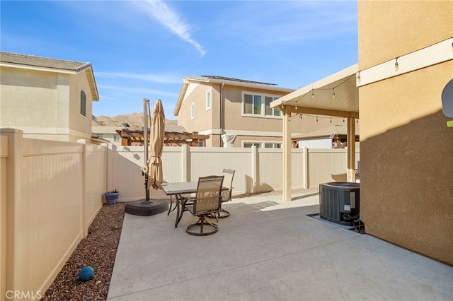 view of patio with cooling unit and a fenced backyard