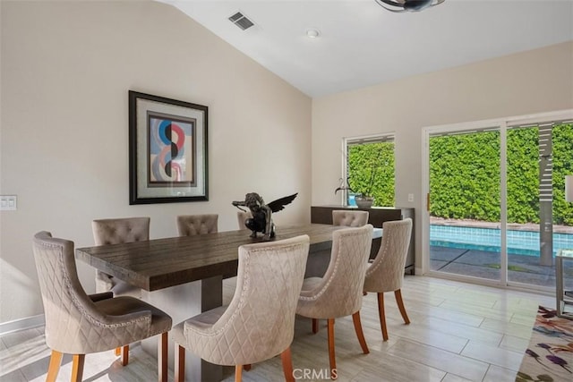 dining area with vaulted ceiling