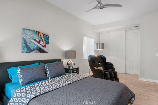 bedroom featuring ceiling fan, a closet, and light hardwood / wood-style flooring