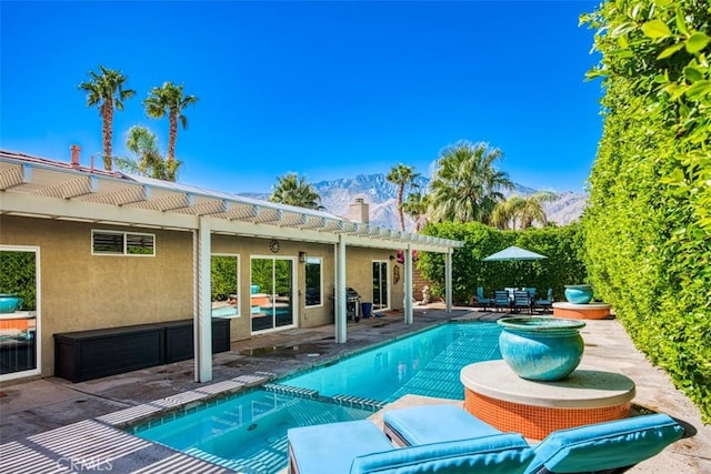 view of pool with a mountain view, a patio, and a pergola