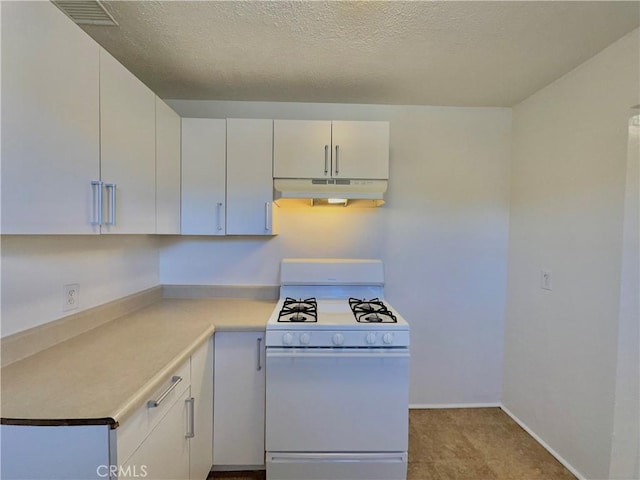 kitchen with a textured ceiling, white cabinets, and white range with gas stovetop