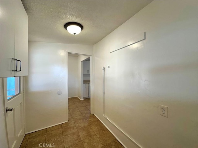 corridor featuring a textured ceiling