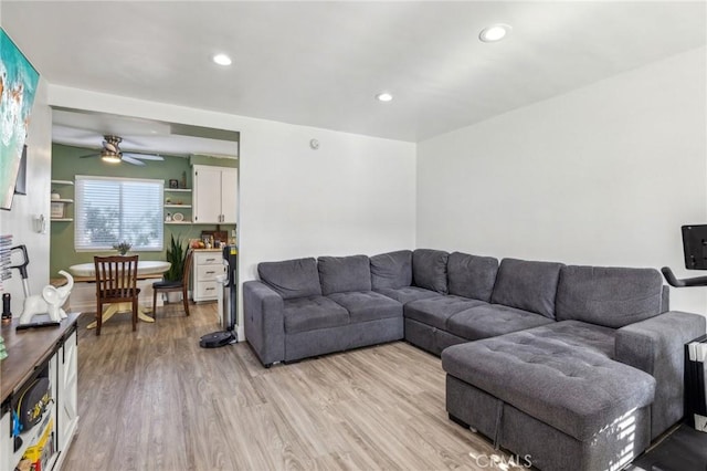 living room featuring ceiling fan and light hardwood / wood-style floors