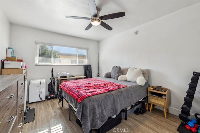 bedroom with ceiling fan and light hardwood / wood-style floors