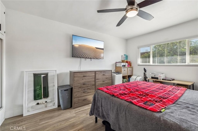 bedroom with ceiling fan and hardwood / wood-style flooring