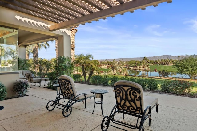 view of patio with a water and mountain view, a pergola, and outdoor lounge area