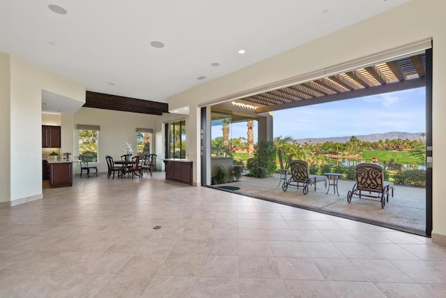 view of patio / terrace with a pergola and a mountain view