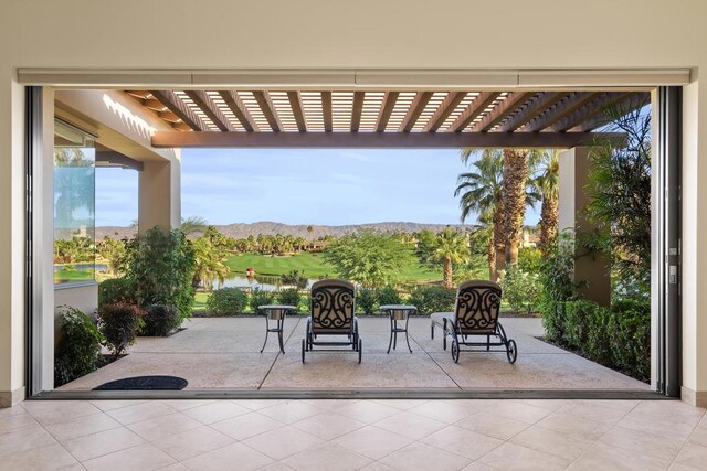 view of patio / terrace with a mountain view and a pergola