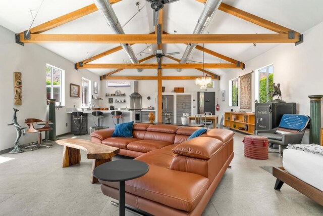 living room with high vaulted ceiling, beam ceiling, and a chandelier