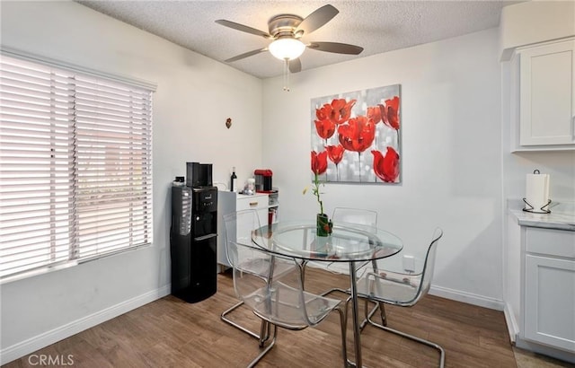 dining space featuring ceiling fan, a textured ceiling, and light wood-type flooring