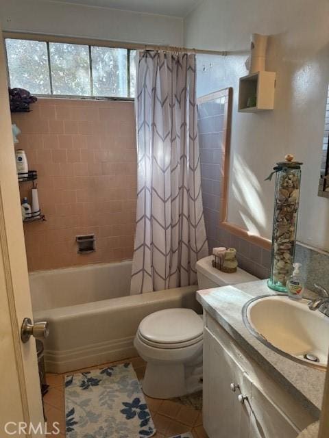 full bathroom with tile patterned floors, vanity, toilet, and shower / bath combination with curtain