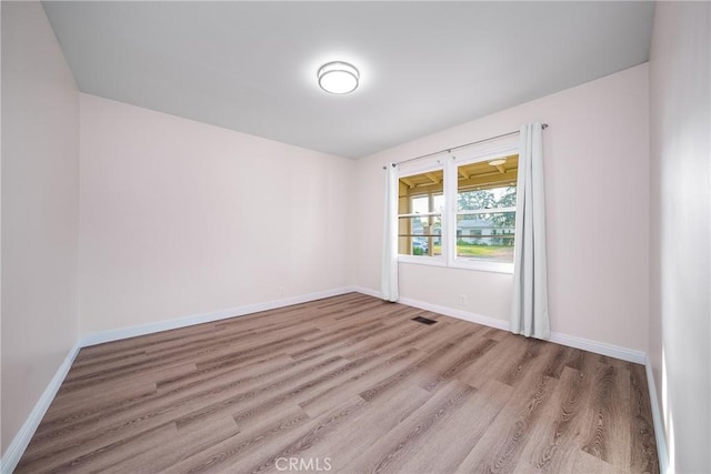 unfurnished room featuring light hardwood / wood-style floors