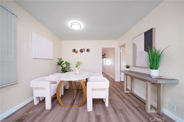 dining room with light hardwood / wood-style floors