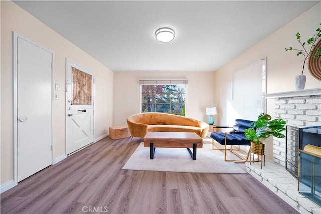 sitting room featuring a fireplace and hardwood / wood-style flooring