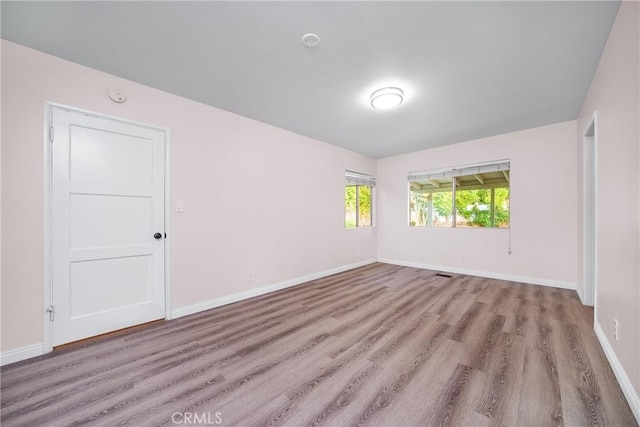 empty room with light hardwood / wood-style floors