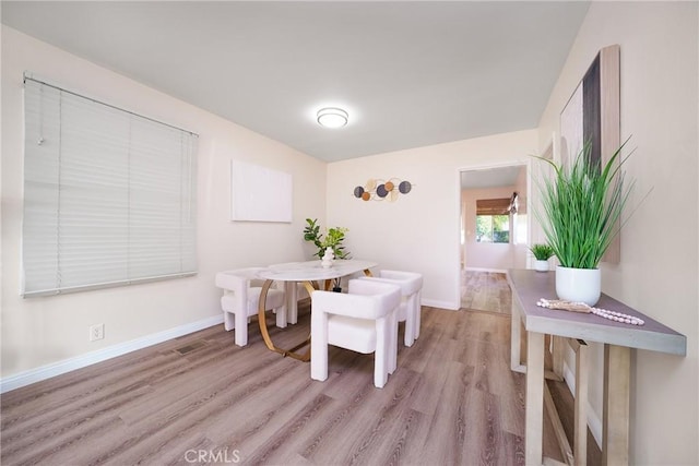 dining area with light hardwood / wood-style floors