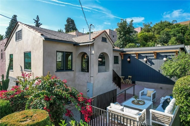 rear view of property featuring an outdoor living space