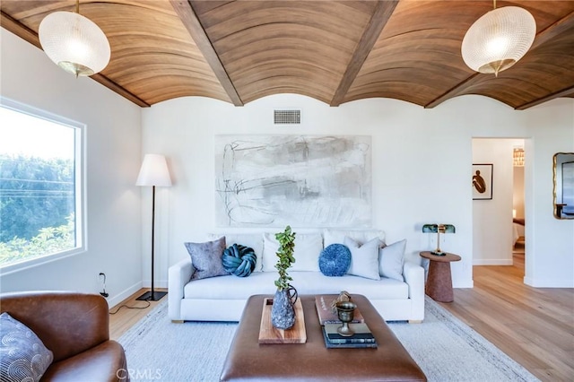 living room with brick ceiling, lofted ceiling, and light hardwood / wood-style flooring