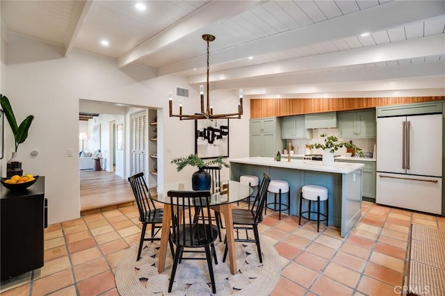 tiled dining room with beam ceiling and an inviting chandelier