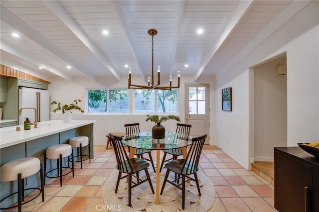 dining space featuring beam ceiling, light tile patterned floors, and sink