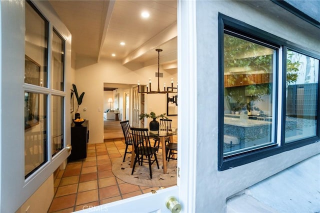 tiled dining room featuring a chandelier