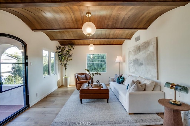 living room featuring a healthy amount of sunlight, brick ceiling, vaulted ceiling with beams, and light hardwood / wood-style floors