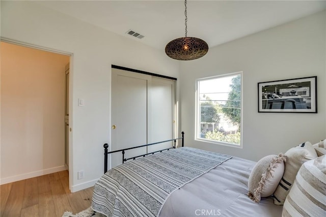 bedroom featuring a closet and light hardwood / wood-style flooring