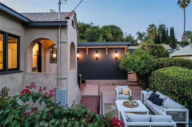 patio terrace at dusk with an outdoor hangout area