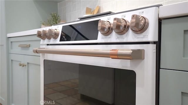 room details featuring white cabinets and range