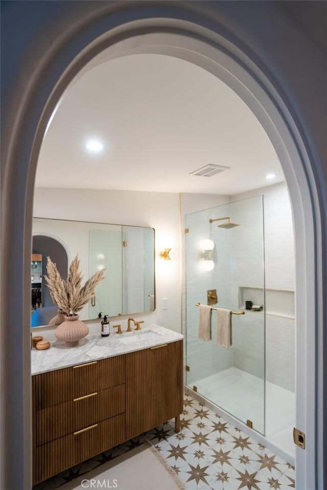 bathroom with walk in shower and vanity