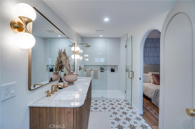 bathroom featuring walk in shower and vanity