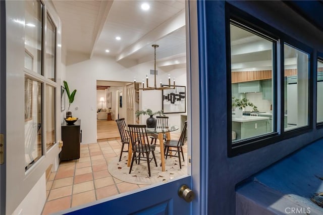 dining room featuring beam ceiling, a notable chandelier, and light tile patterned flooring