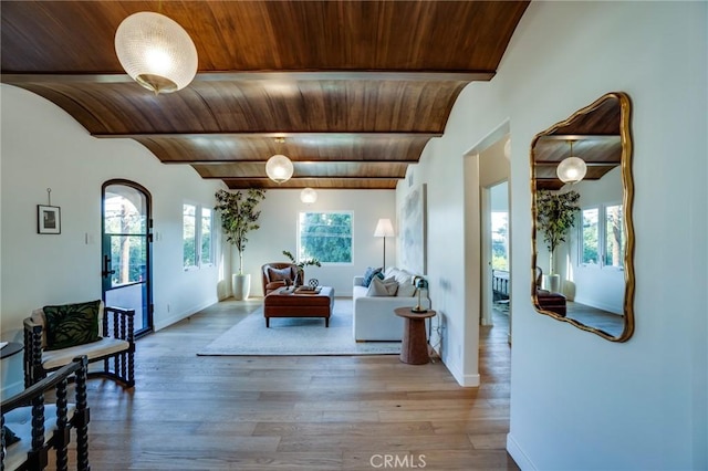 living room featuring hardwood / wood-style floors, brick ceiling, and beam ceiling