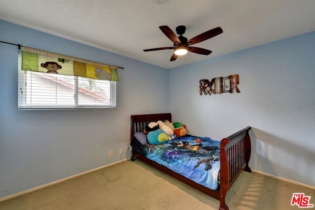 bedroom featuring ceiling fan and carpet