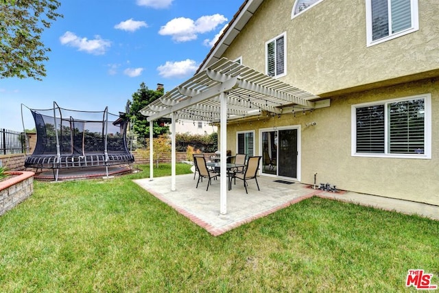 view of yard featuring a trampoline, a patio area, and a pergola