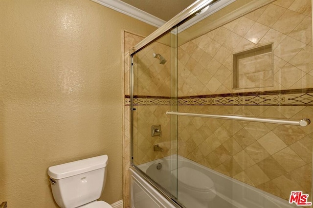 bathroom featuring combined bath / shower with glass door, crown molding, and toilet