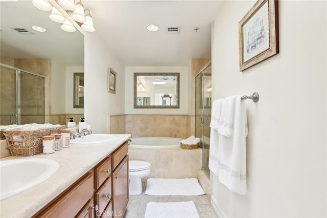 full bathroom featuring toilet, vanity, independent shower and bath, and tile patterned floors